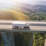 trucks-highway-mountain-sunset
